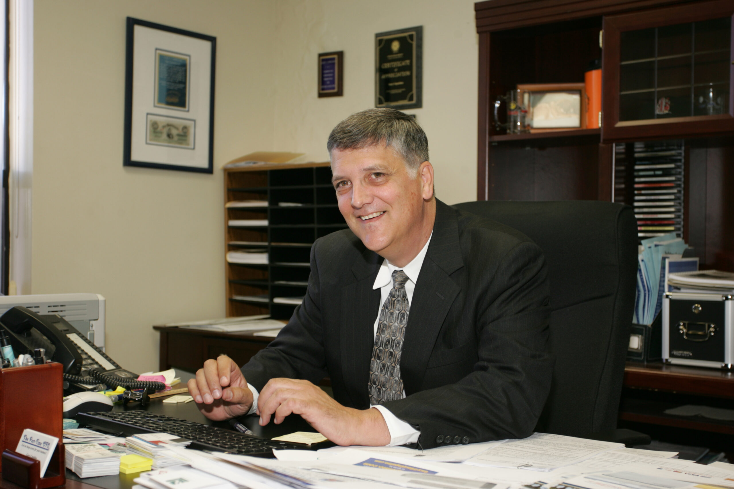 Gary Capolino working with a client's business accounting